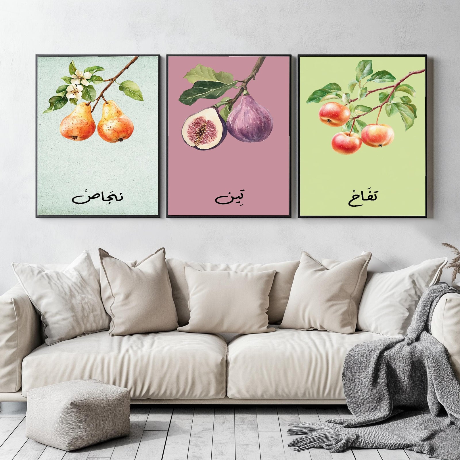 Set of 3 framed canvas triptych featuring soft watercolor botanical illustrations of pear, fig and apple branches with Arabic calligraphy labels on pastel mint, pink and green backgrounds, displayed above a neutral sofa.