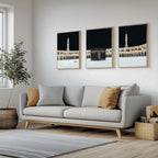 Set of 3 framed canvas triptych showing dramatic night views of Masjid Al-Haram with the Kaaba centered, glowing gold minarets and white marble courtyard against a deep black sky, displayed above a neutral sofa.