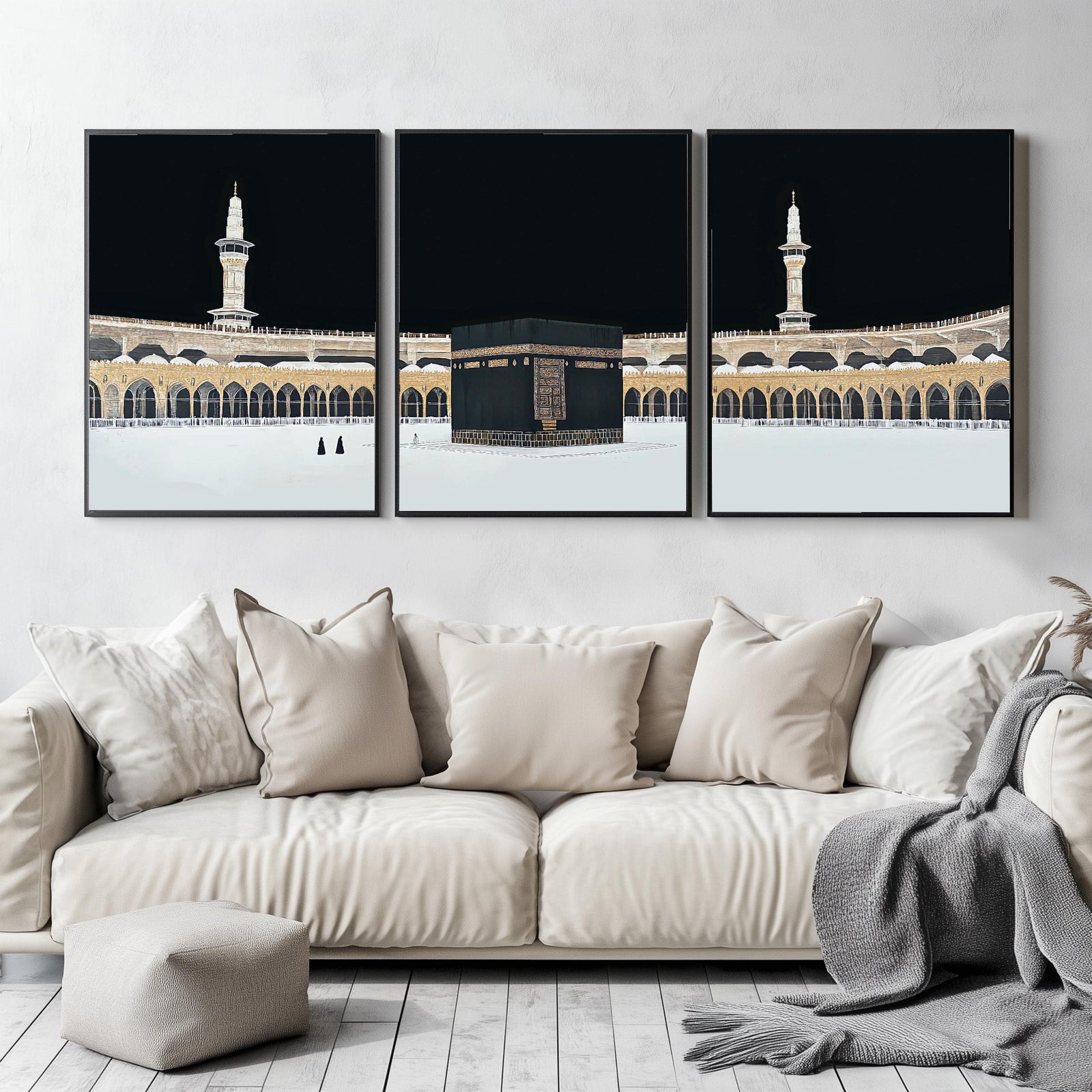 Set of 3 framed canvas triptych showing dramatic night views of Masjid Al-Haram with the Kaaba centered, glowing gold minarets and white marble courtyard against a deep black sky, displayed above a neutral sofa.