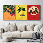 Set of 3 framed canvas triptych featuring bold retro illustrations of orange, lemon and cherry with Arabic calligraphy labels on vibrant orange, yellow and red backgrounds, displayed above a neutral sofa.
