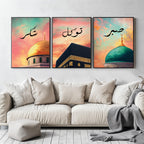 Set of 3 framed canvas triptych with Shukr, Tawakkul and Sabr in Arabic calligraphy above close-up mosque domes against a dreamy coral and teal sunset sky, displayed above a neutral sofa in a modern living room.