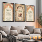Set of 3 framed canvas triptych featuring Surah Al-Rahman, Al-Quran Al-Kareem and Surah Al-Fatiha in Arabic calligraphy inside floral pink and gold Islamic arches on a warm cream background, displayed above a neutral sofa.