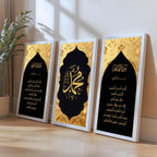 Set of 3 framed canvas triptych featuring Surah Al-Maoun, Muhammad in Arabic calligraphy and Surah Al-Fatiha in gold on dramatic black arch panels with gold textured background, displayed above a neutral sofa.