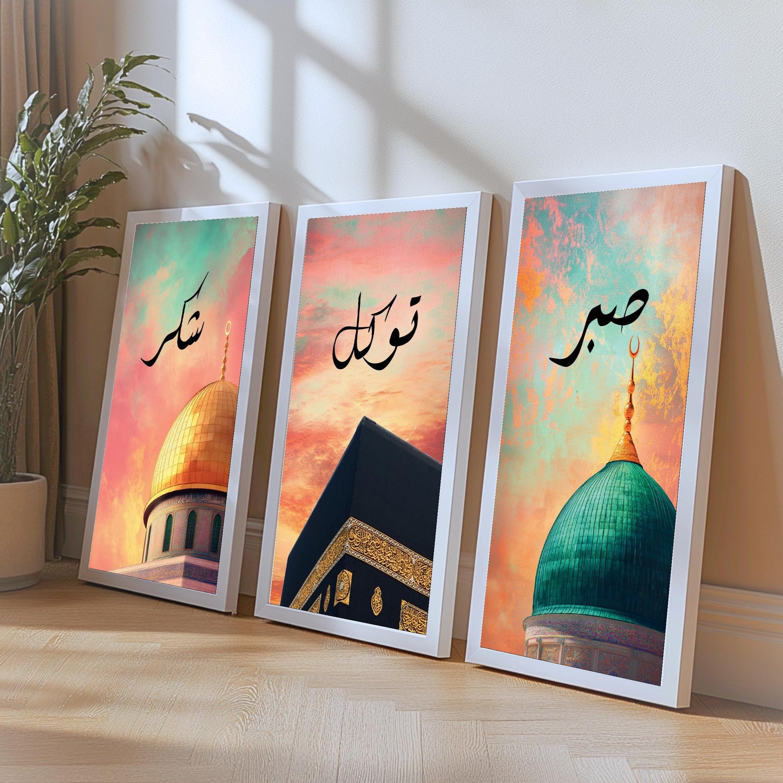 Set of 3 framed canvas triptych with Shukr, Tawakkul and Sabr in Arabic calligraphy above close-up mosque domes against a dreamy coral and teal sunset sky, displayed above a neutral sofa in a modern living room.