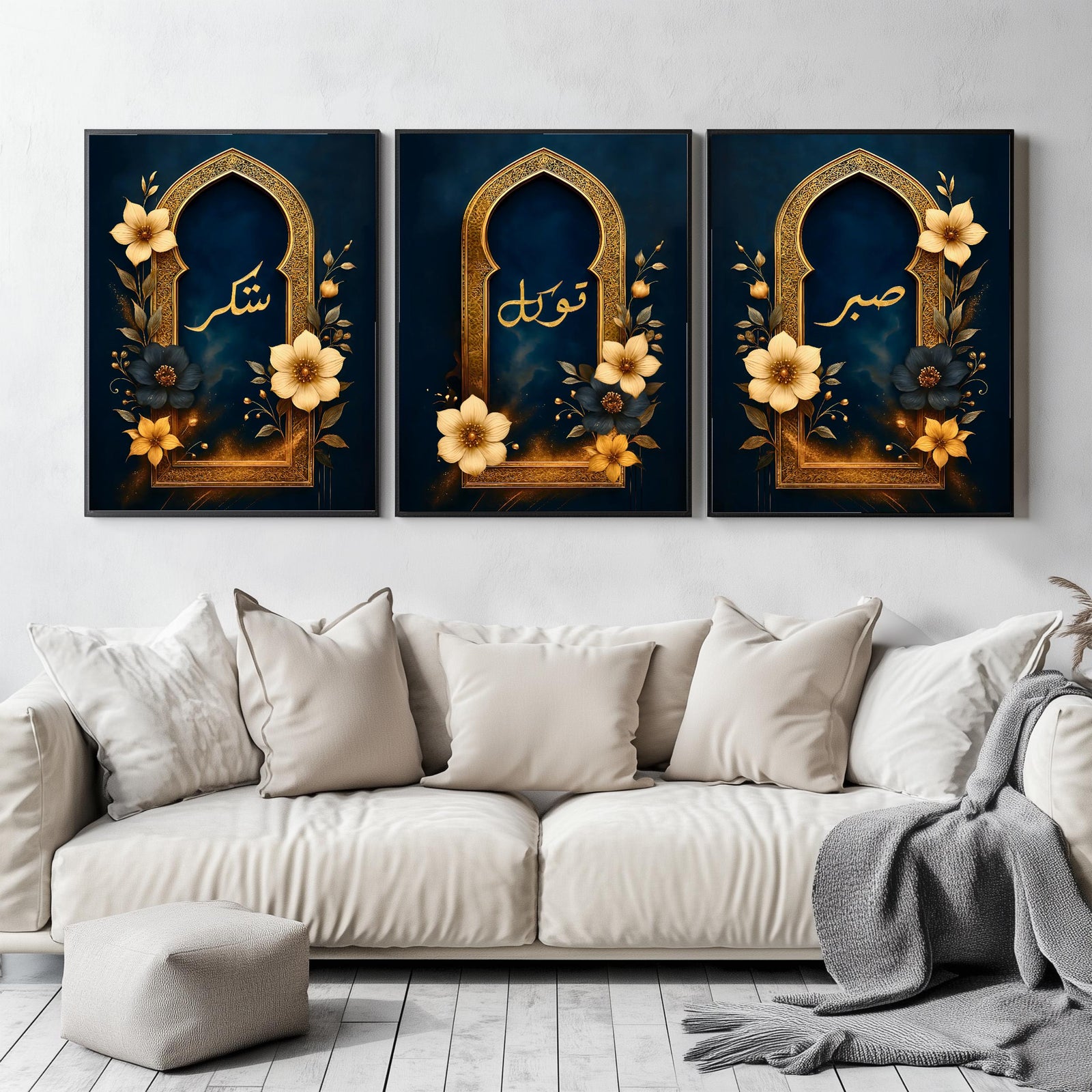 Set of 3 framed canvas triptych with Sabr, Shukr and Tawakkul in gold Arabic calligraphy inside ornate navy and gold Islamic arches surrounded by yellow and dark blue flowers, displayed above a grey sofa.