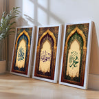 Set of 3 framed canvas triptych featuring Allah, Bismillah and Muhammad in Arabic calligraphy inside ornate gold Islamic arches on rich blue, purple and green jewel tone backgrounds, displayed above a neutral sofa.