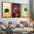 Set of 3 framed canvas triptych showing the Kaaba, Dome of the Rock and Al-Masjid An-Nabawi with oversized peony flowers and birds in flight, each panel on a distinct yellow, purple and green background.