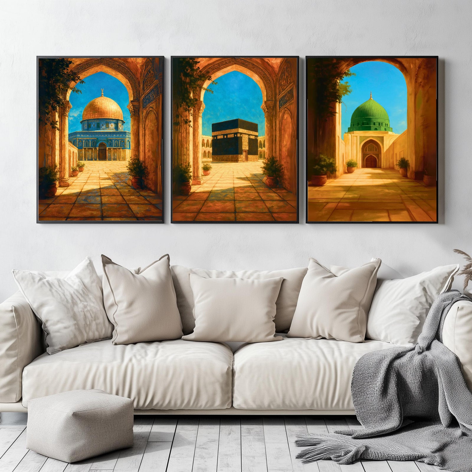 Set of 3 framed canvas triptych depicting the Dome of the Rock, the Kaaba and Al-Masjid An-Nabawi viewed through warm stone arches in a rich painterly style, displayed above a neutral sofa in a modern living room.