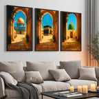 Set of 3 framed canvas triptych depicting the Dome of the Rock, the Kaaba and Al-Masjid An-Nabawi viewed through warm stone arches in a rich painterly style, displayed above a neutral sofa in a modern living room.