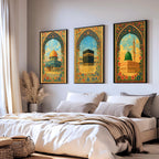Set of 3 framed canvas triptych depicting Al-Masjid An-Nabawi, the Kaaba and the Dome of the Rock in warm golden mosaic style with vibrant floral arch borders, displayed above a neutral sofa.