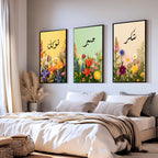 Set of 3 framed canvas triptych with Tawakkul, Sabr and Shukr in Arabic calligraphy above vibrant wildflower gardens on pastel yellow, green and peach backgrounds, displayed above a neutral sofa.