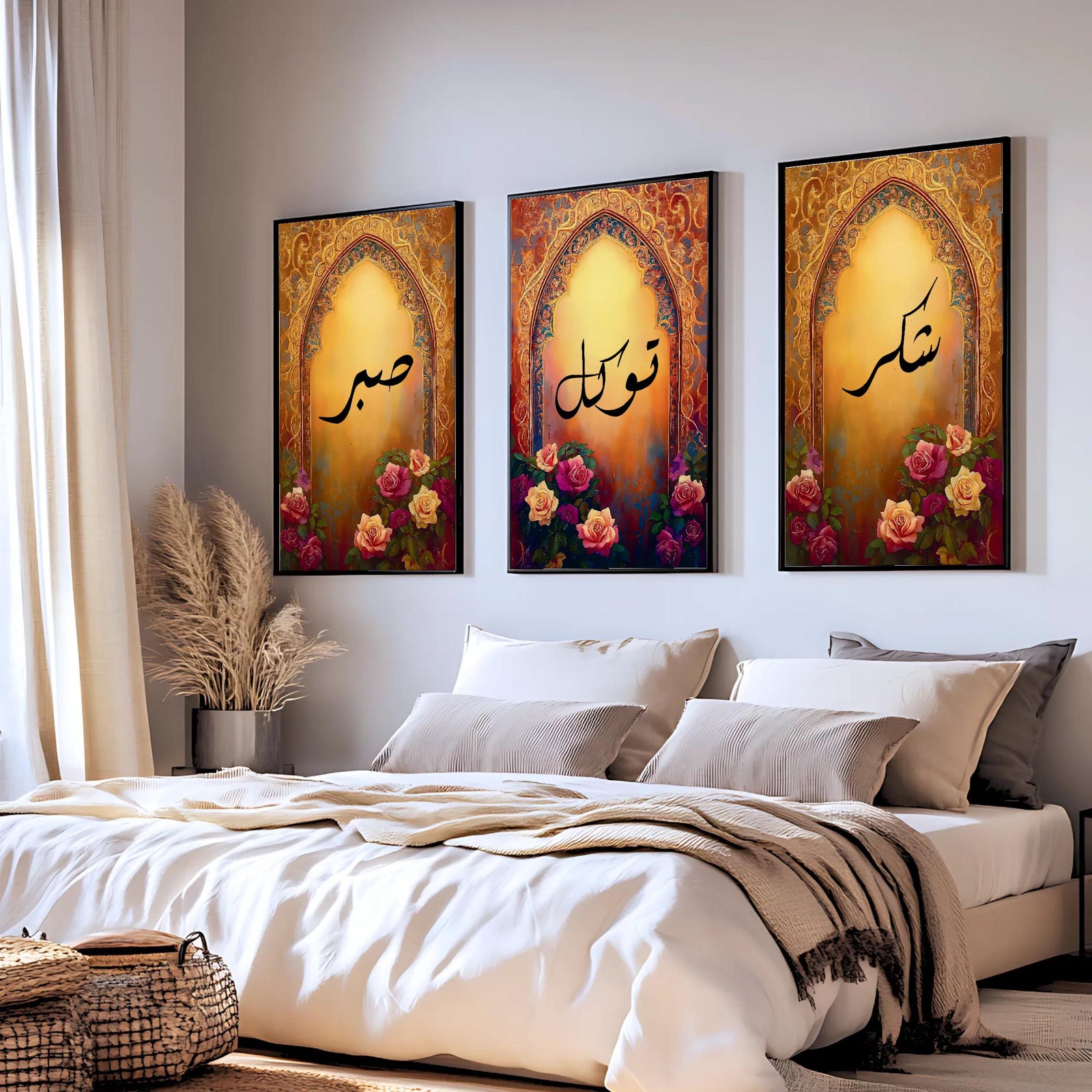 Set of 3 framed canvas triptych with Sabr, Shukr and Tawakkul Arabic calligraphy inside golden Islamic arches, rich red and amber tones with painted roses, displayed on a warm neutral wall above a grey sofa.