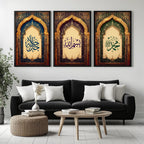 Set of 3 framed canvas triptych featuring Allah, Bismillah and Muhammad in Arabic calligraphy inside ornate gold Islamic arches on rich blue, purple and green jewel tone backgrounds, displayed above a neutral sofa.
