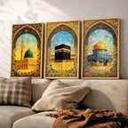 Set of 3 framed canvas triptych depicting Al-Masjid An-Nabawi, the Kaaba and the Dome of the Rock in warm golden mosaic style with vibrant floral arch borders, displayed above a neutral sofa.
