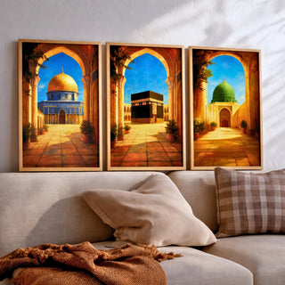 Set of 3 framed canvas triptych depicting the Dome of the Rock, the Kaaba and Al-Masjid An-Nabawi viewed through warm stone arches in a rich painterly style, displayed above a neutral sofa in a modern living room.