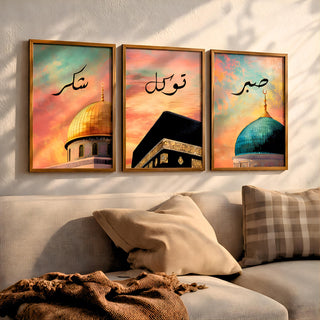 Set of 3 framed canvas triptych with Shukr, Tawakkul and Sabr in Arabic calligraphy above close-up mosque domes against a dreamy coral and teal sunset sky, displayed above a neutral sofa in a modern living room.