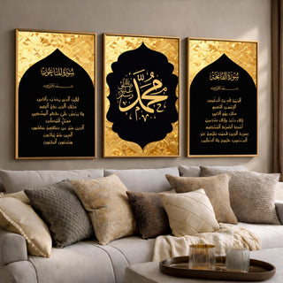 Set of 3 framed canvas triptych featuring Surah Al-Maoun, Muhammad in Arabic calligraphy and Surah Al-Fatiha in gold on dramatic black arch panels with gold textured background, displayed above a neutral sofa.