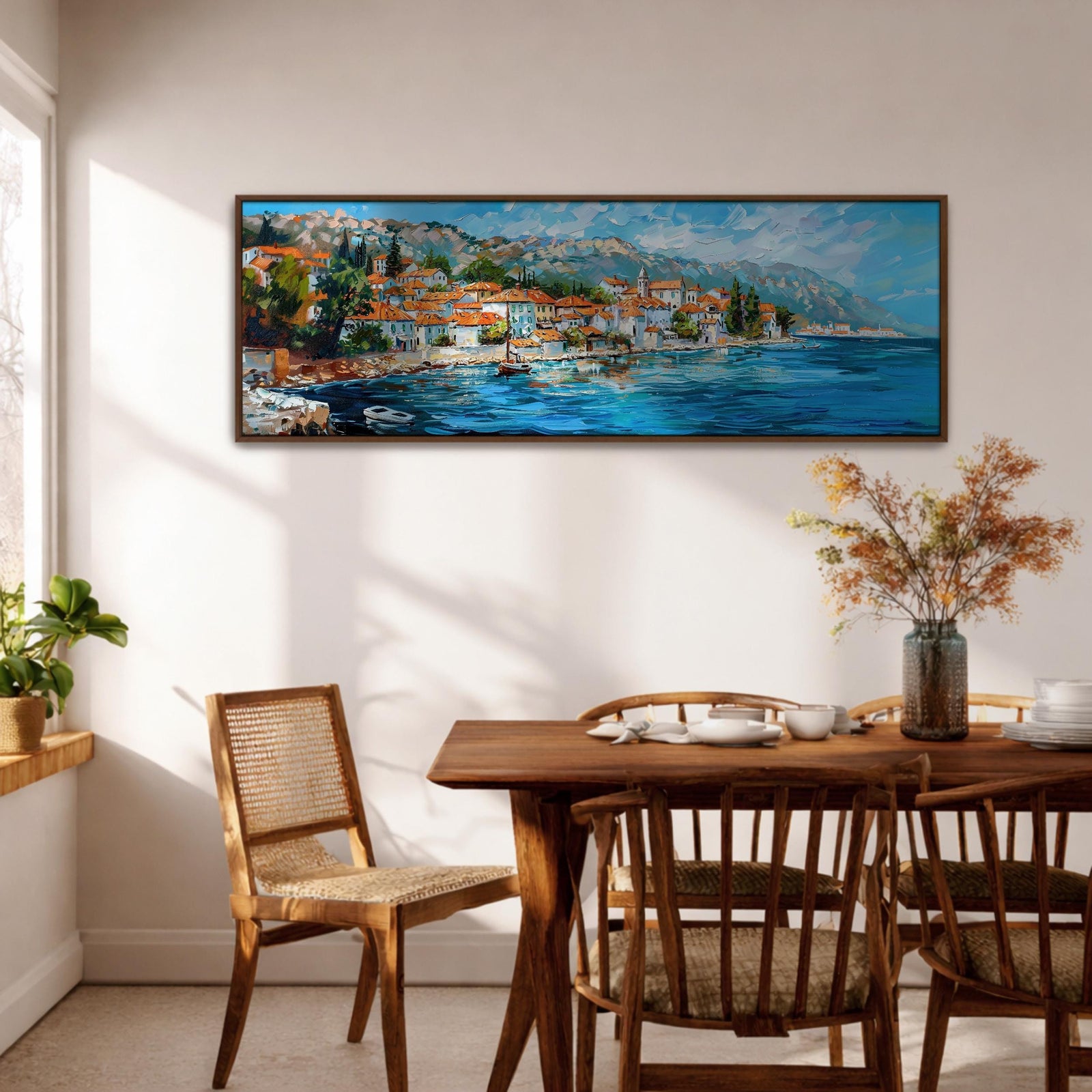Panoramic impressionist style painting of a Mediterranean coastal village with terracotta roof houses clustered along a blue seaside harbor, small boats floating on reflective water, and layered mountains rising in the background under a bright sky. Loose palette knife brushstrokes create textured waves, sunlit buildings, and vibrant coastal colors across the long horizontal composition.