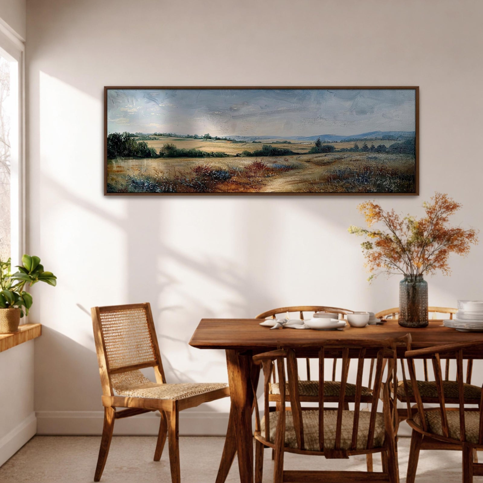Panoramic landscape painting of a wildflower meadow with tall grasses and scattered field flowers stretching across open prairie land. Soft textured brushstrokes in earthy greens, golds, and muted rust tones lead toward distant rolling hills beneath a cloudy sky, creating a wide countryside scene with natural depth.