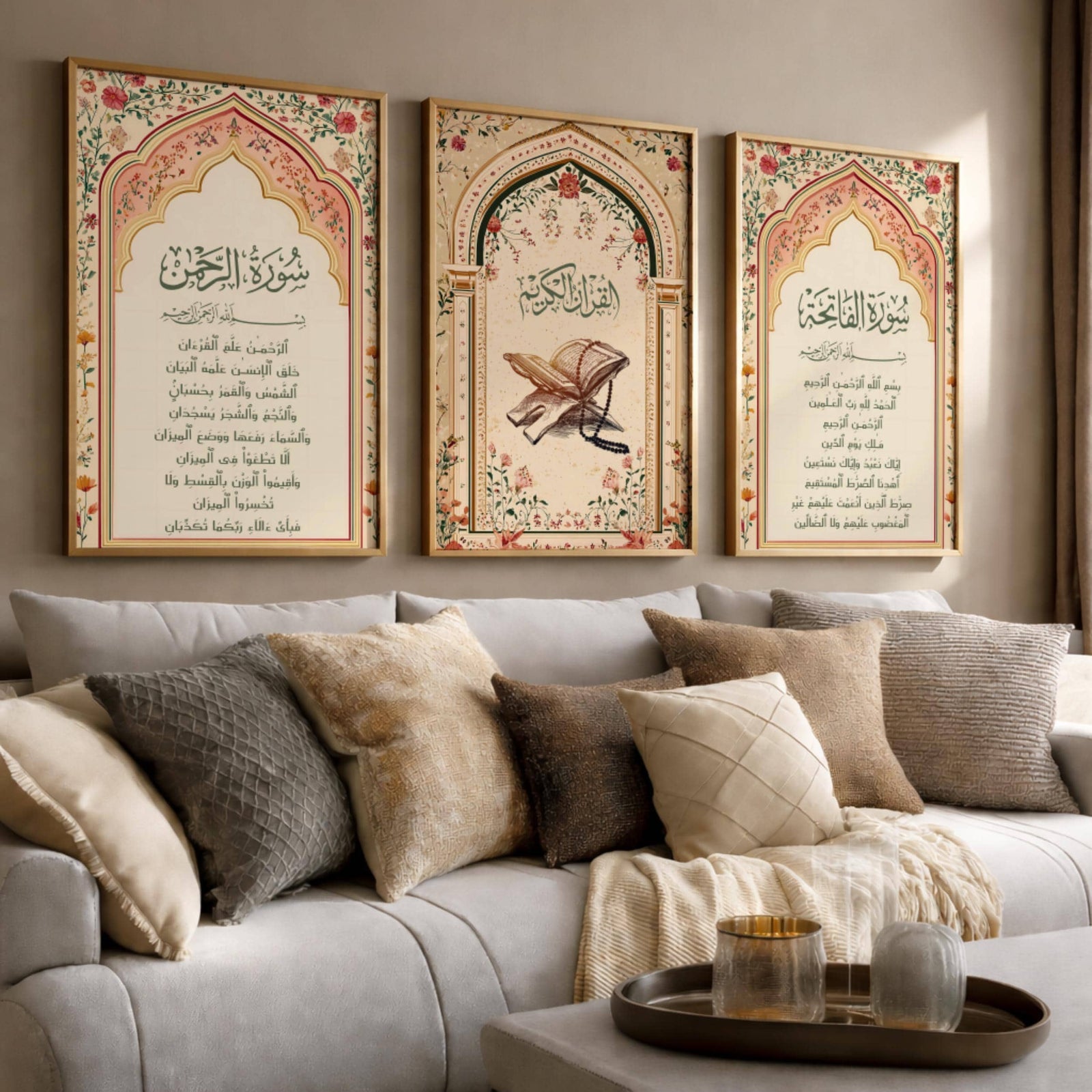 Set of 3 framed canvas triptych featuring Surah Al-Rahman, Al-Quran Al-Kareem and Surah Al-Fatiha in Arabic calligraphy inside floral pink and gold Islamic arches on a warm cream background, displayed above a neutral sofa.