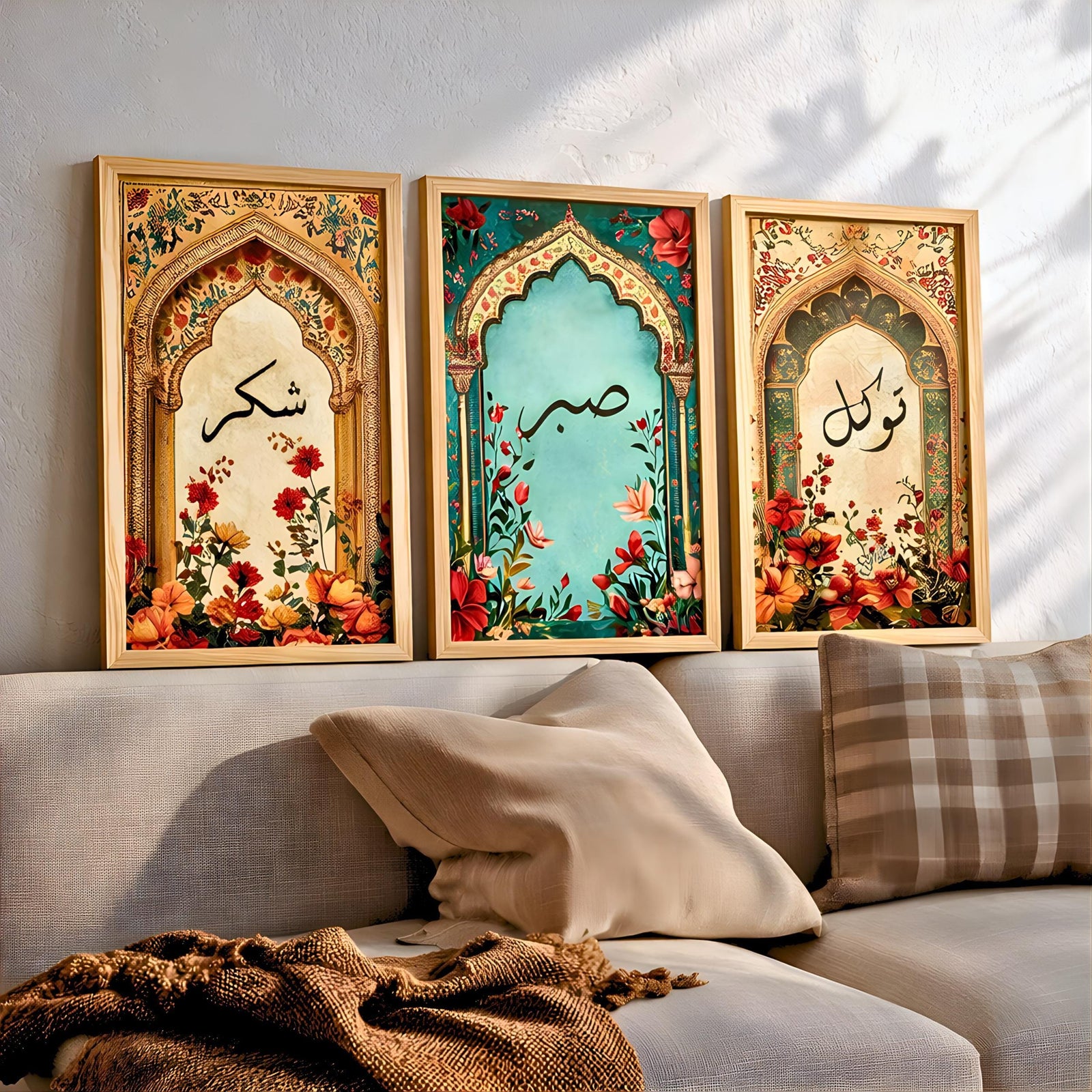 Set of 3 framed canvas triptych with Shukr, Sabr and Tawakkul in Arabic calligraphy inside gold, teal and vintage arches surrounded by lush red and orange Persian garden floral blooms, displayed above a neutral sofa.