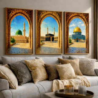 Set of 3 framed canvas triptych showing Al-Masjid An-Nabawi, the Kaaba and the Dome of the Rock viewed through realistic rustic sandstone arches with cobblestone courtyards under a bright blue sky, displayed above a neutral sofa.