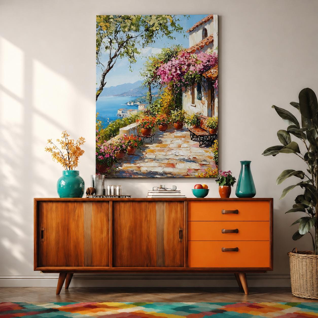 A framed canvas painting depicting a Mediterranean patio with terracotta pots filled with vibrant flowers, a stone tiled floor, and a coastal landscape featuring blue sea and distant mountains under a clear sky, rendered in a realistic style capturing the charm of an Italian seaside terrace.
