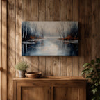 A framed canvas painting depicting a serene winter lake landscape with bare trees reflected in still water. The scene features a quiet woodland setting with leafless trees and subtle earthy tones, capturing the calm and reflective nature of a winter forest by the lake.