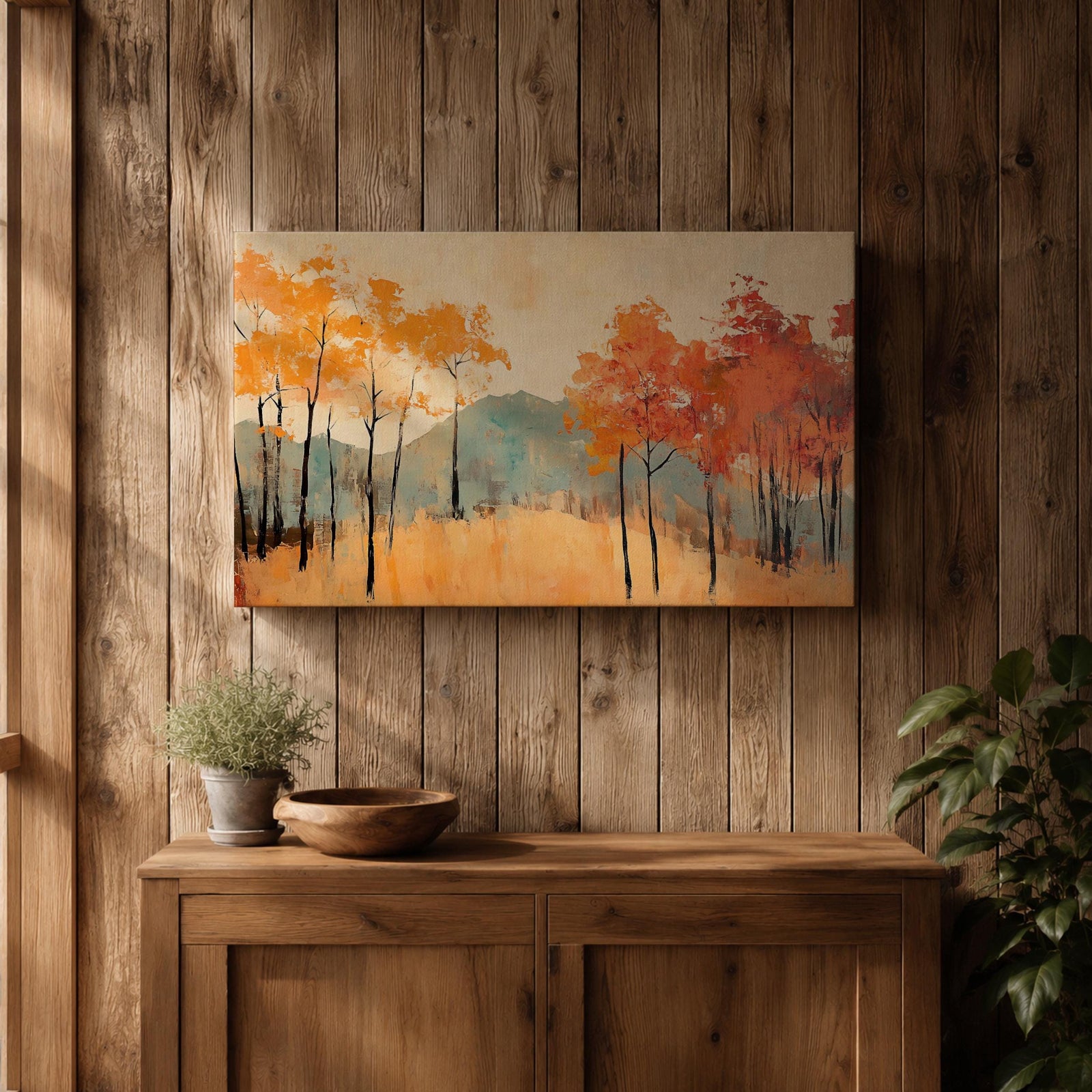 A framed abstract painting of an autumn forest landscape featuring tall slender trees with orange and red foliage and a muted mountain backdrop. The composition uses textured brush strokes to create a modern impression of fall trees in a natural setting.