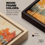 A framed abstract painting of an autumn forest landscape featuring tall slender trees with orange and red foliage and a muted mountain backdrop. The composition uses textured brush strokes to create a modern impression of fall trees in a natural setting.