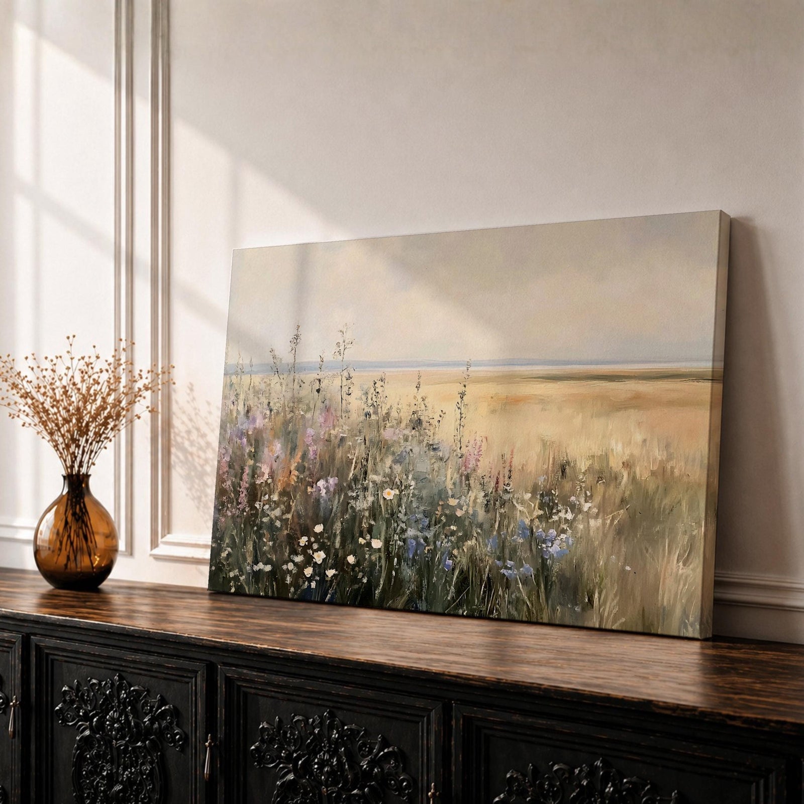 A vintage-style oil painting print depicting a wildflower meadow with various delicate flowers and grasses in soft, neutral tones. The artwork captures the natural beauty of field plants with textured brushstrokes and an impressionistic style, framed in a warm wooden frame.