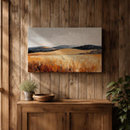 A vintage-style framed canvas painting depicting a vast landscape of golden fields and rolling hills under a muted sky. The textured brushstrokes emphasize the natural prairie scene with tall grasses in the foreground and distant hills, capturing a serene rural environment.