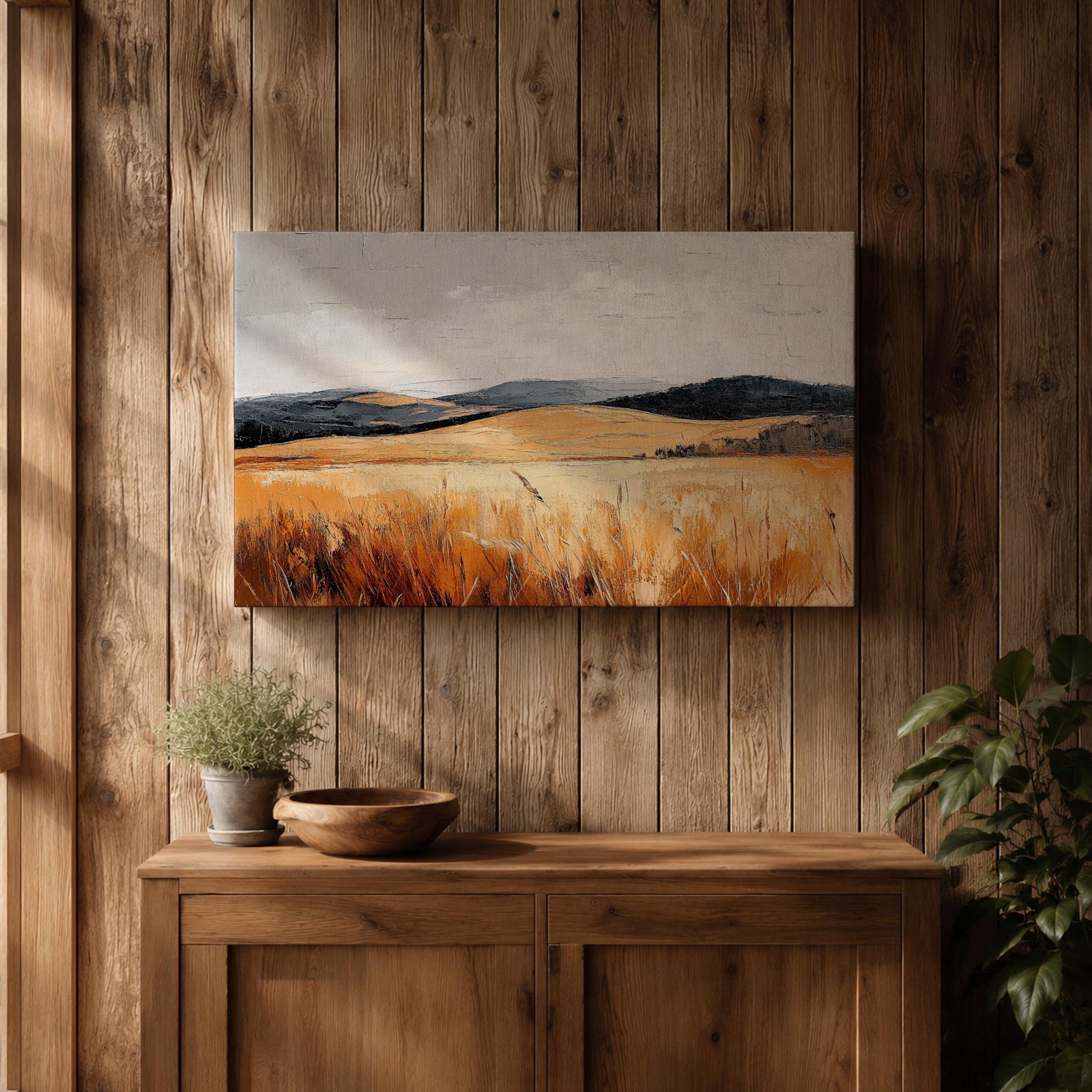 A vintage-style framed canvas painting depicting a vast landscape of golden fields and rolling hills under a muted sky. The textured brushstrokes emphasize the natural prairie scene with tall grasses in the foreground and distant hills, capturing a serene rural environment.