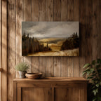 A framed canvas painting depicting a wildflower meadow landscape with rolling hills and clusters of trees under a cloudy sky. The artwork captures a natural countryside scene with detailed brushwork and a warm, rustic atmosphere emphasizing the beauty of open fields and forest edges.