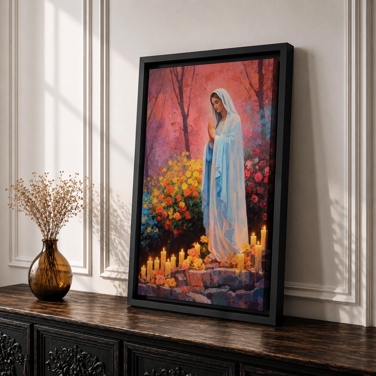 A detailed painting of Our Lady of Lourdes depicts the Virgin Mary standing with hands clasped in prayer, surrounded by blooming flowers and lit candles. The image captures a serene religious scene symbolizing the Marian apparition, rendered in a realistic style with vibrant colors and soft shading.