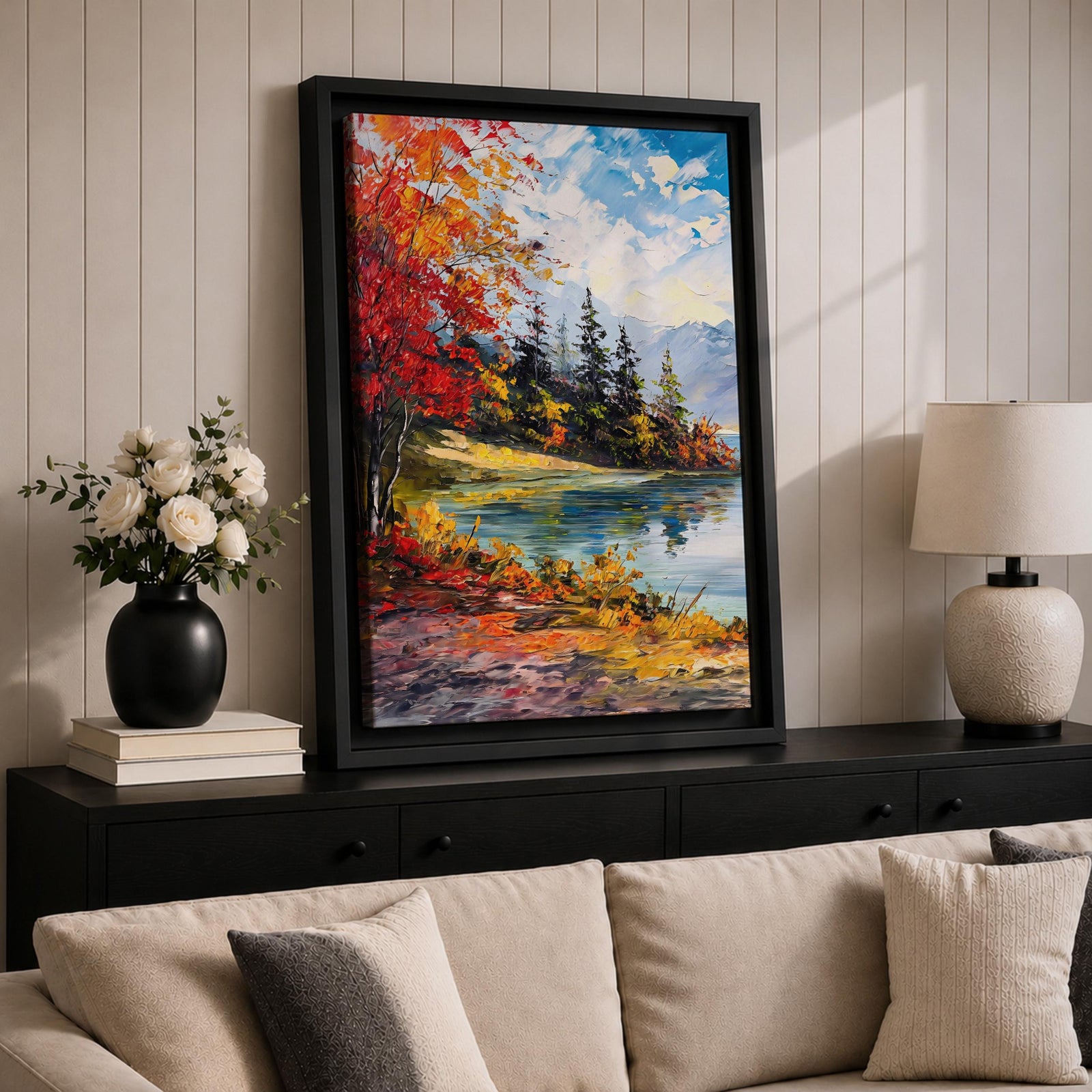 A vibrant impasto painting depicting an autumn lake scene with colorful red and orange foliage on the shore, evergreen trees, and distant mountains under a partly cloudy blue sky, rendered with thick textured brushstrokes creating a rich, dynamic landscape composition.