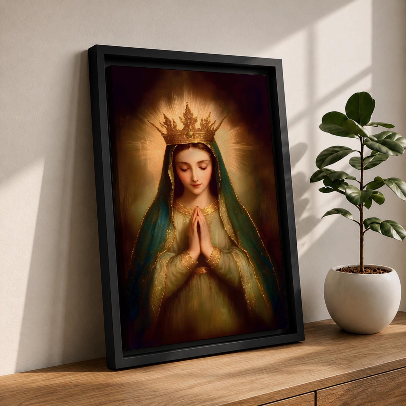 Painting of the Virgin Mary crowned as Queen of Heaven with a radiant golden crown and halo, shown with eyes closed and hands gently folded in prayer. She wears a long veil and flowing robe while soft classical brushwork and a glowing background emphasize the Marian figure in a devotional royal portrait.