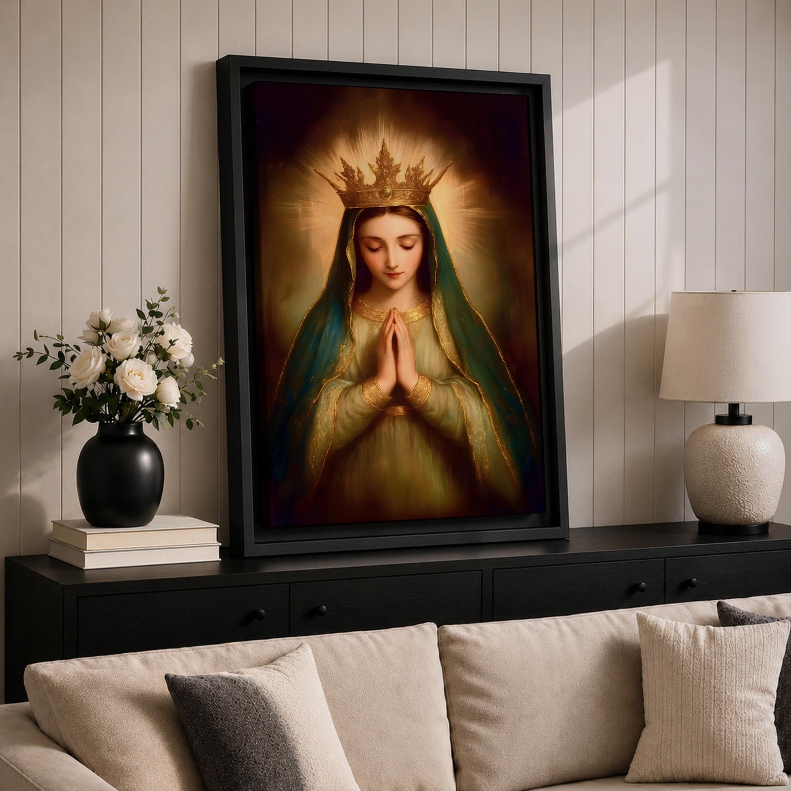Painting of the Virgin Mary crowned as Queen of Heaven with a radiant golden crown and halo, shown with eyes closed and hands gently folded in prayer. She wears a long veil and flowing robe while soft classical brushwork and a glowing background emphasize the Marian figure in a devotional royal portrait.