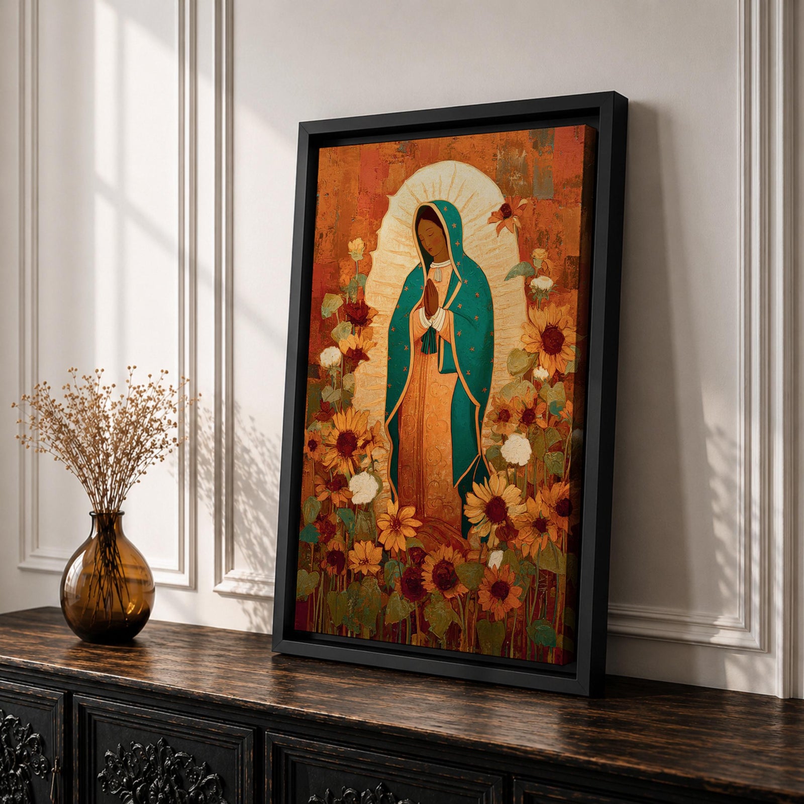 This artwork depicts Our Lady of Guadalupe, also known as the Virgin of Guadalupe, surrounded by vibrant sunflowers and floral elements in a vintage style. The figure is shown with hands clasped in prayer, wearing a teal mantle adorned with stars, set against a warm textured background.