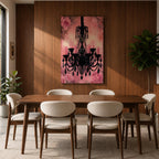 A framed canvas print featuring a detailed black chandelier silhouette with multiple hanging crystals and candle flames, set against a pink floral background with roses, blending ornate lighting design with a soft botanical motif.