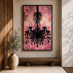 A framed canvas print featuring a detailed black chandelier silhouette with multiple hanging crystals and candle flames, set against a pink floral background with roses, blending ornate lighting design with a soft botanical motif.