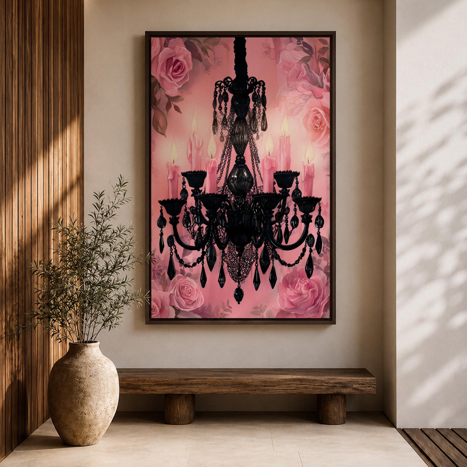 A framed canvas print featuring a detailed black chandelier silhouette with multiple hanging crystals and candle flames, set against a pink floral background with roses, blending ornate lighting design with a soft botanical motif.
