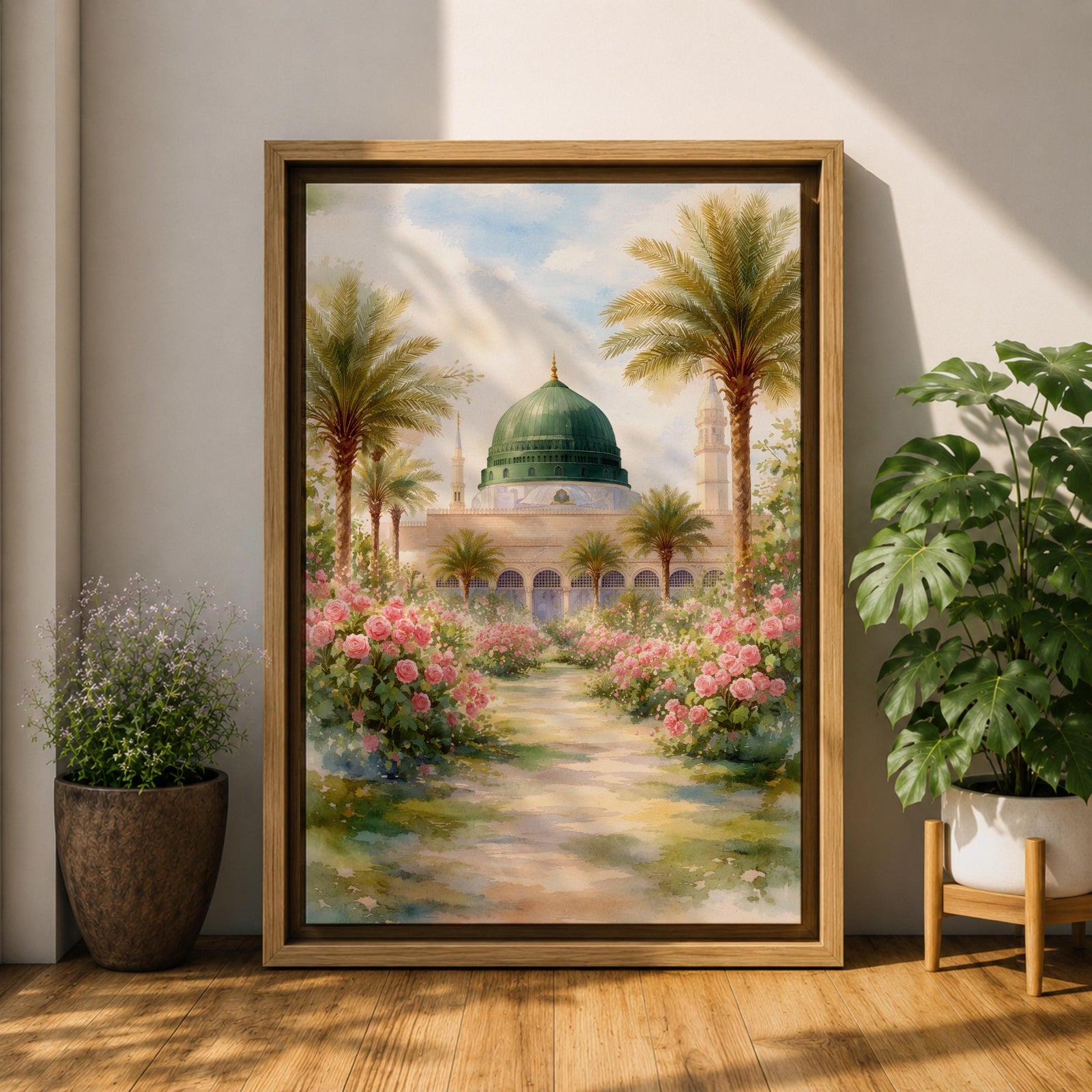 Framed canvas wall art of the Prophet’s Mosque in Medina featuring the iconic green dome, surrounded by palm trees and blooming pink flowers along a sunlit garden path, creating a peaceful and serene Islamic landscape scene for home decor.
