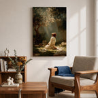 Framed artwork of Jesus praying in the Garden of Gethsemane, kneeling beneath a tree as soft rays of light shine down from above. Set in a modern living room, the canvas rests on a wooden console beside plants and neutral decor.
