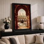 Artwork showing the Kaaba in Mecca viewed through an ornate Islamic archway with intricate carved stone details, overlooking the Masjid al Haram courtyard filled with pilgrims and surrounded by minarets and mosque architecture under warm sunlight.