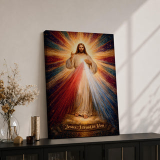 A radiant depiction of Divine Mercy of Jesus shows Jesus standing with one hand raised in blessing and the other pointing to his heart, from which red and pale rays emanate. The figure is surrounded by vibrant rays of light, rendered in a classical religious art style on canvas.