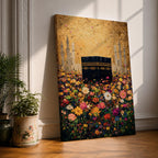 The Kaaba stands at the center of a vibrant field of multicolored flowers, surrounded by softly rendered mosque minarets in the background, set beneath a radiant golden sky with textured brushwork that blends architectural form with blooming botanical elements in a richly layered and luminous composition.