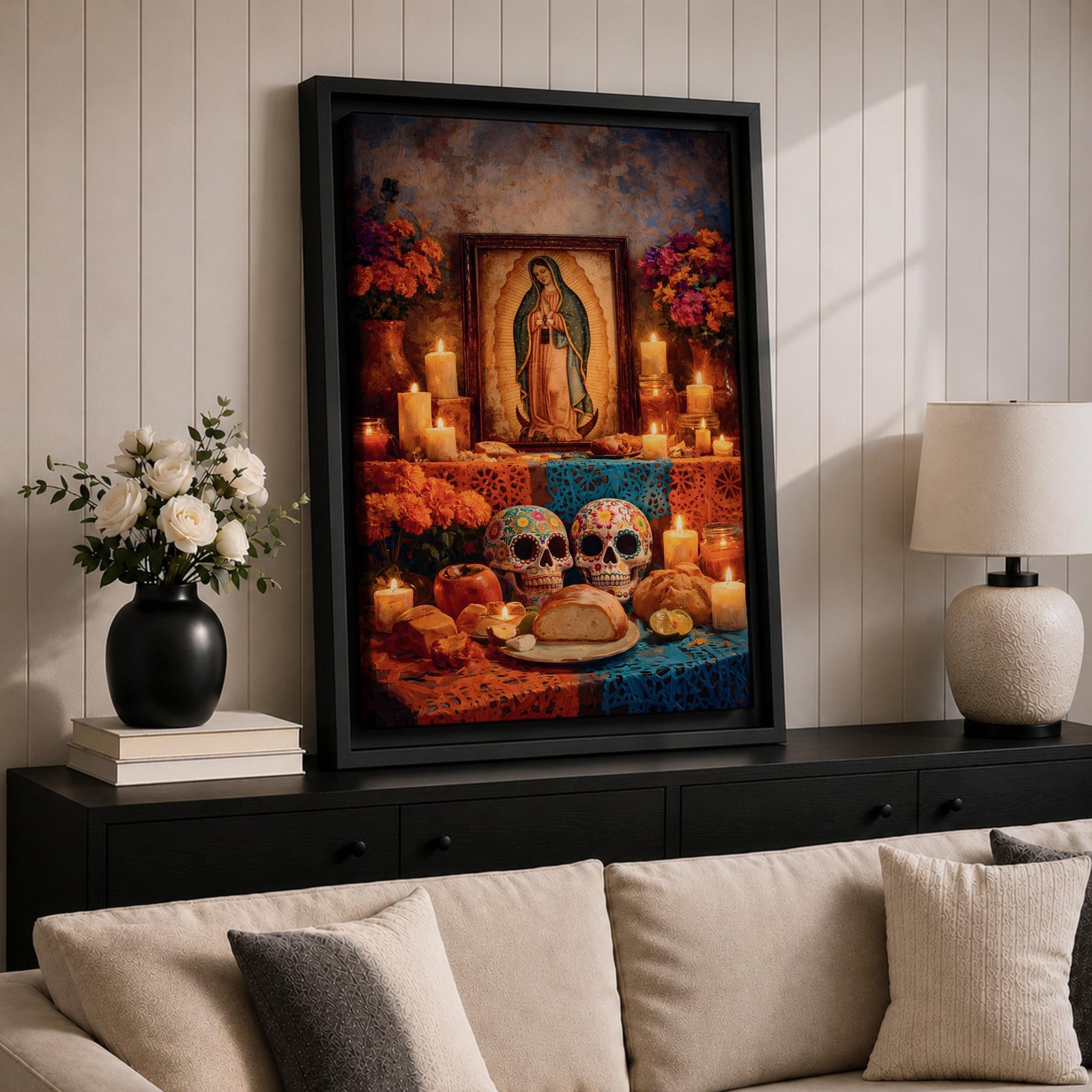 A framed canvas wall art depicting Our Lady of Guadalupe with a traditional Mexican altar featuring candles, flowers, decorated sugar skulls, bread, and fruit, rendered in a detailed, realistic style emphasizing cultural and religious symbolism.