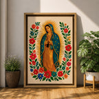 A framed stitched style art print depicting Our Lady of Guadalupe with hands clasped in prayer, surrounded by a radiant golden halo and vibrant floral embroidery in red, blue, and green. The image captures the traditional Mexican Catholic iconography with intricate textile detail and a serene expression.