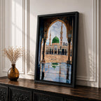 Artwork showing the courtyard of Al-Masjid an-Nabawi viewed through a carved Islamic arch, featuring the iconic green dome of the Prophet’s Mosque with tall minarets, reflective marble floor, and bright sky above the sacred mosque complex in Medina.